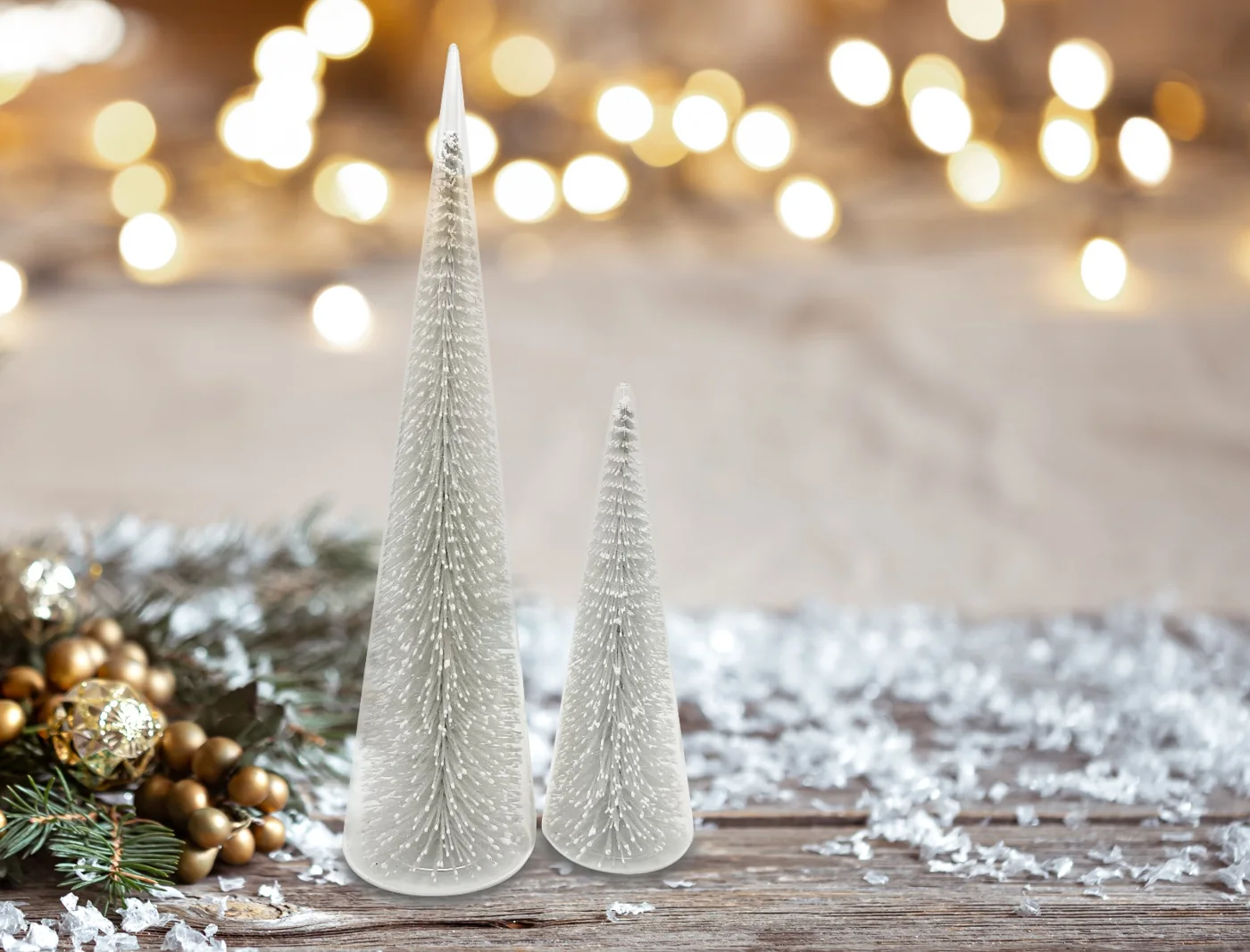 Two clear cone-shaped glass Christmas trees with white branch details